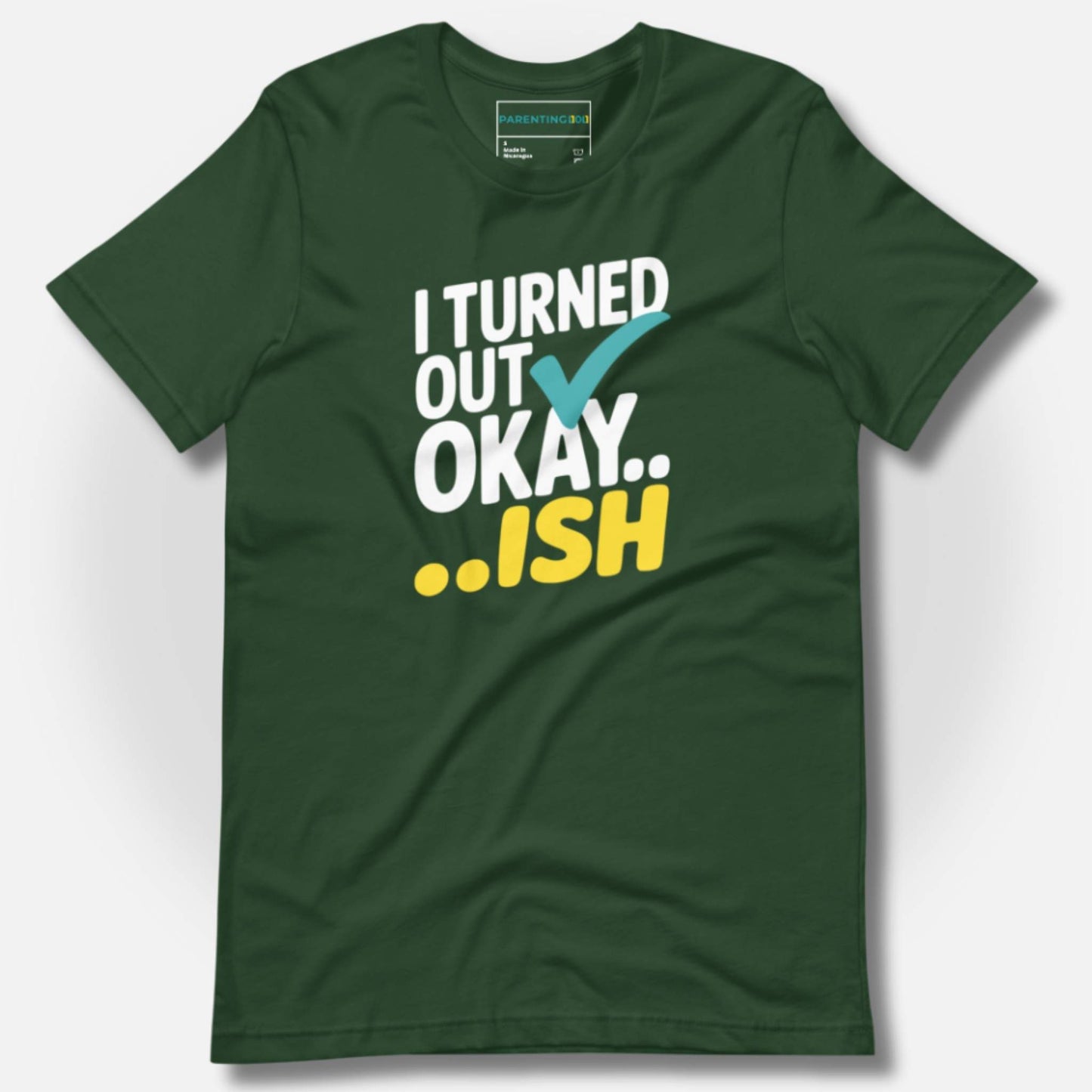 Forest green t-shirt with "I Turned Out Okay...ish" graphic, perfect for parents who embrace the chaos.