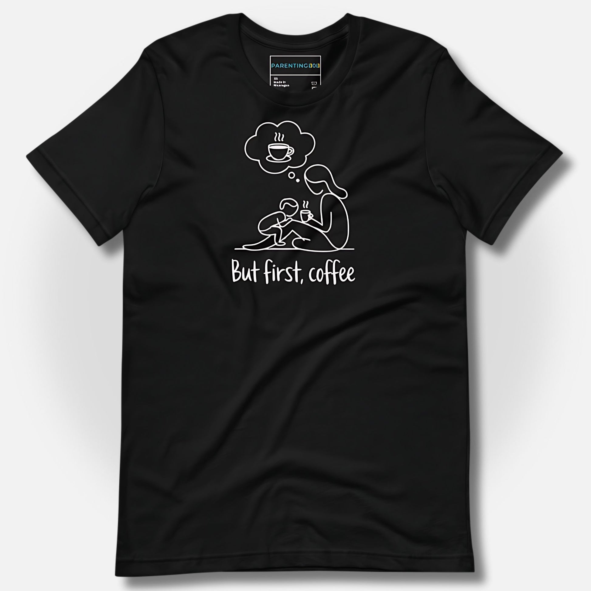 Detail of ParentingLOL's black t-shirt, showcasing the "But first, coffee" design, perfect for a tired, relatable parent needing a laugh.