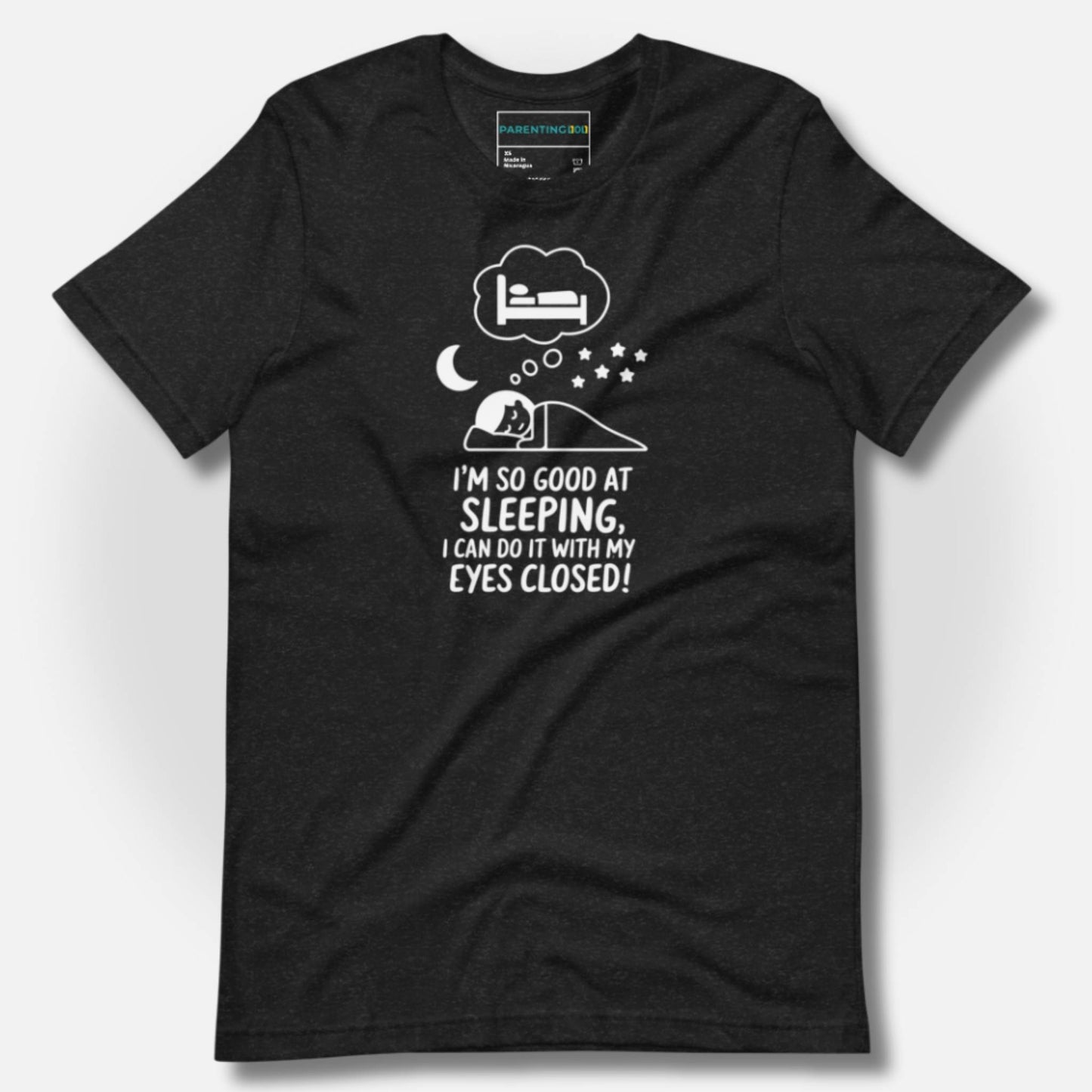 Durable heather black t-shirt with a humorous sleeping parent graphic and "I'm so good at sleeping, I can do it with my eyes closed!" text for funny parenting moments.