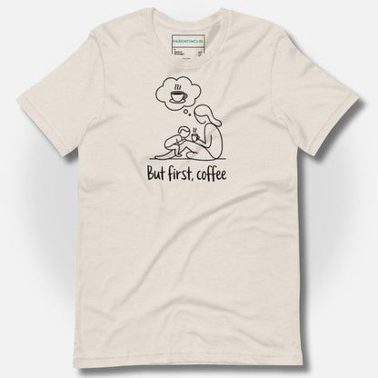 Detail of ParentingLOL's heather dust t-shirt, featuring the "But first, coffee" design, a cozy essential for the busy parent tribe.