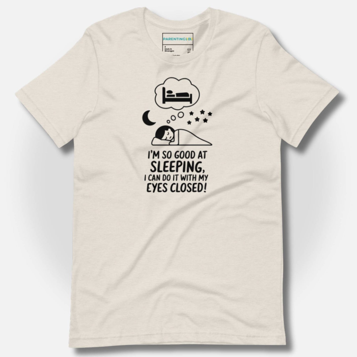 Cozy heather dust t-shirt featuring a funny sleeping parent design and "I'm so good at sleeping, I can do it with my eyes closed!" text, ideal for parents needing a laugh.