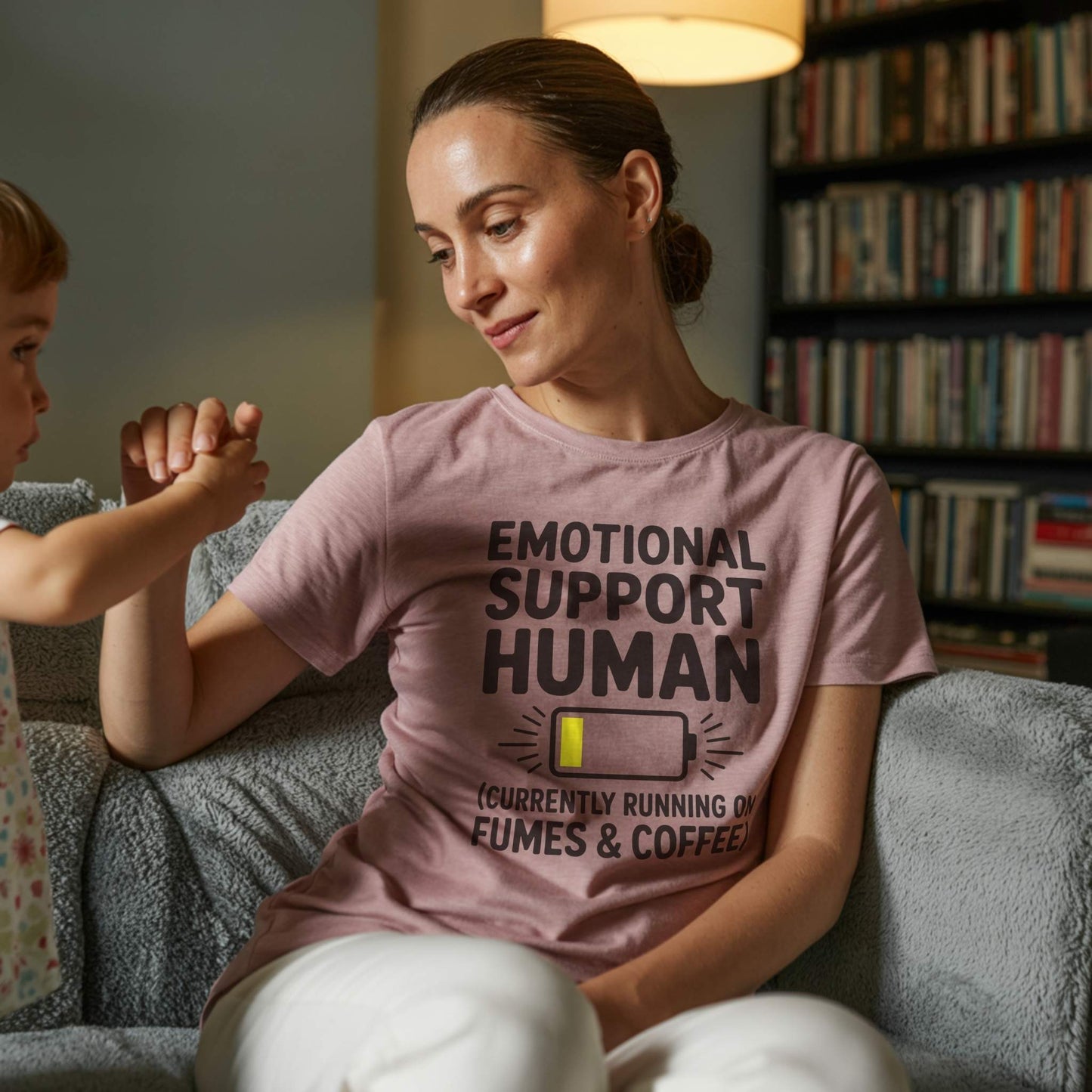 Lifestyle Photo - Mom & Baby; Female parent wearing a Heather Mauve "Emotional Support Human" t-shirt, holding a child's hand, signifying supportive and gentle parent moments.