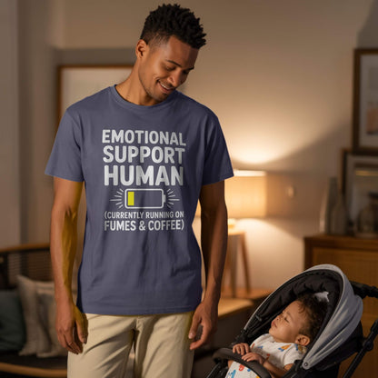 Lifestyle Photo - Dad & Baby; Male parent wearing a navy "Emotional Support Human" t-shirt, looking at a sleeping baby in a stroller, depicting caring dad life.