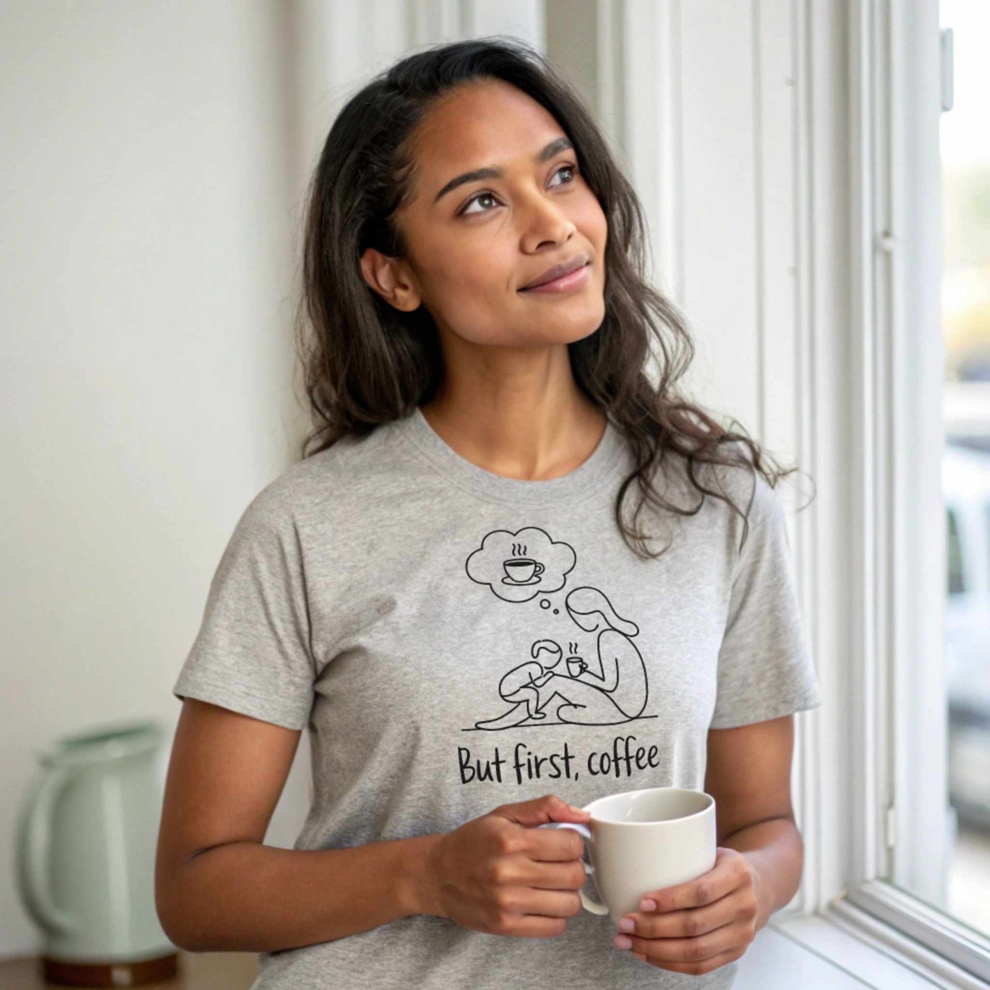 ParentingLOL Hero Shot: Relaxed mom in a heather dust "But first, coffee" tee, finding comfort in daily essentials and parent realness.