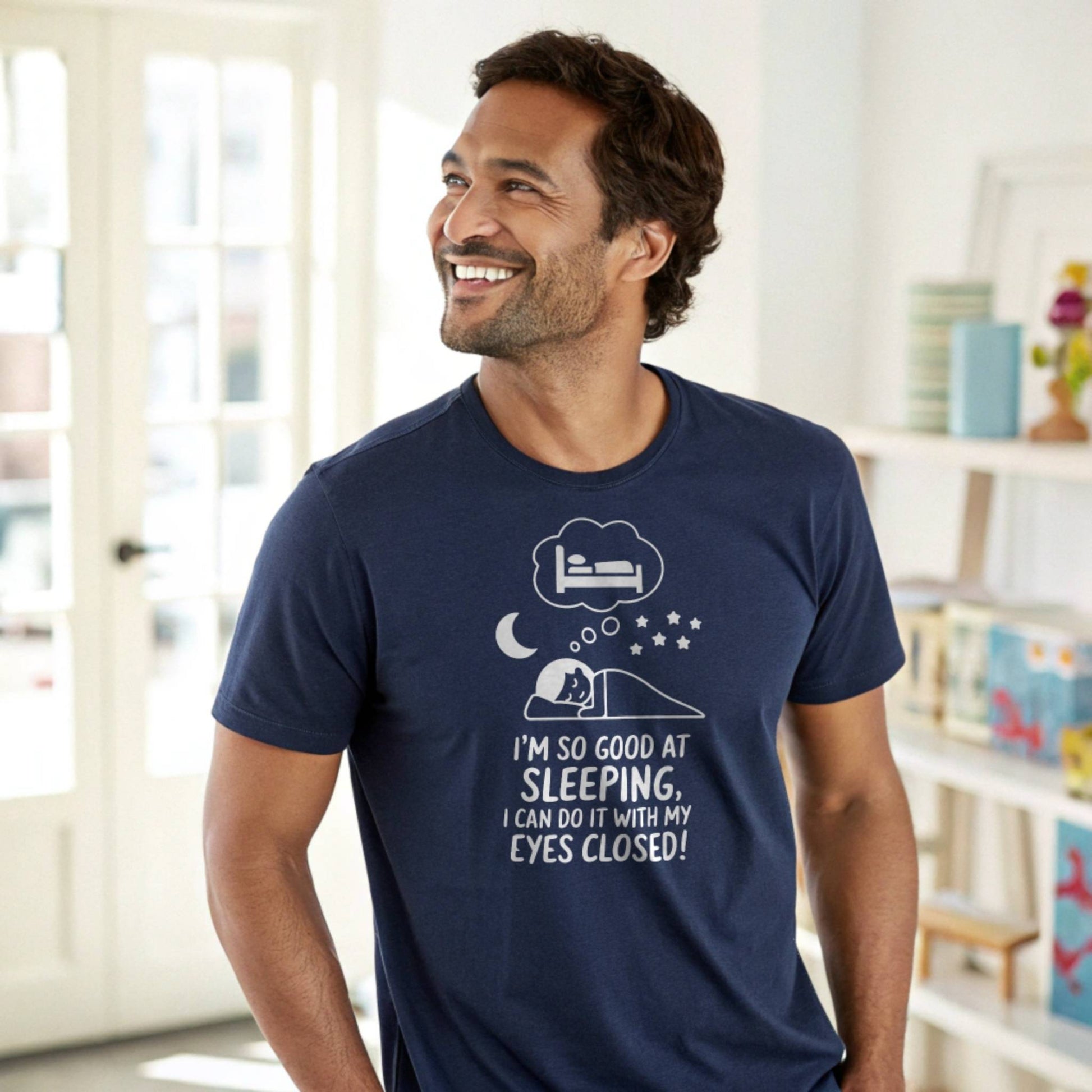 Man smiling in a navy "I'm so good at sleeping" t-shirt, showcasing comfort and relatable parent humor.