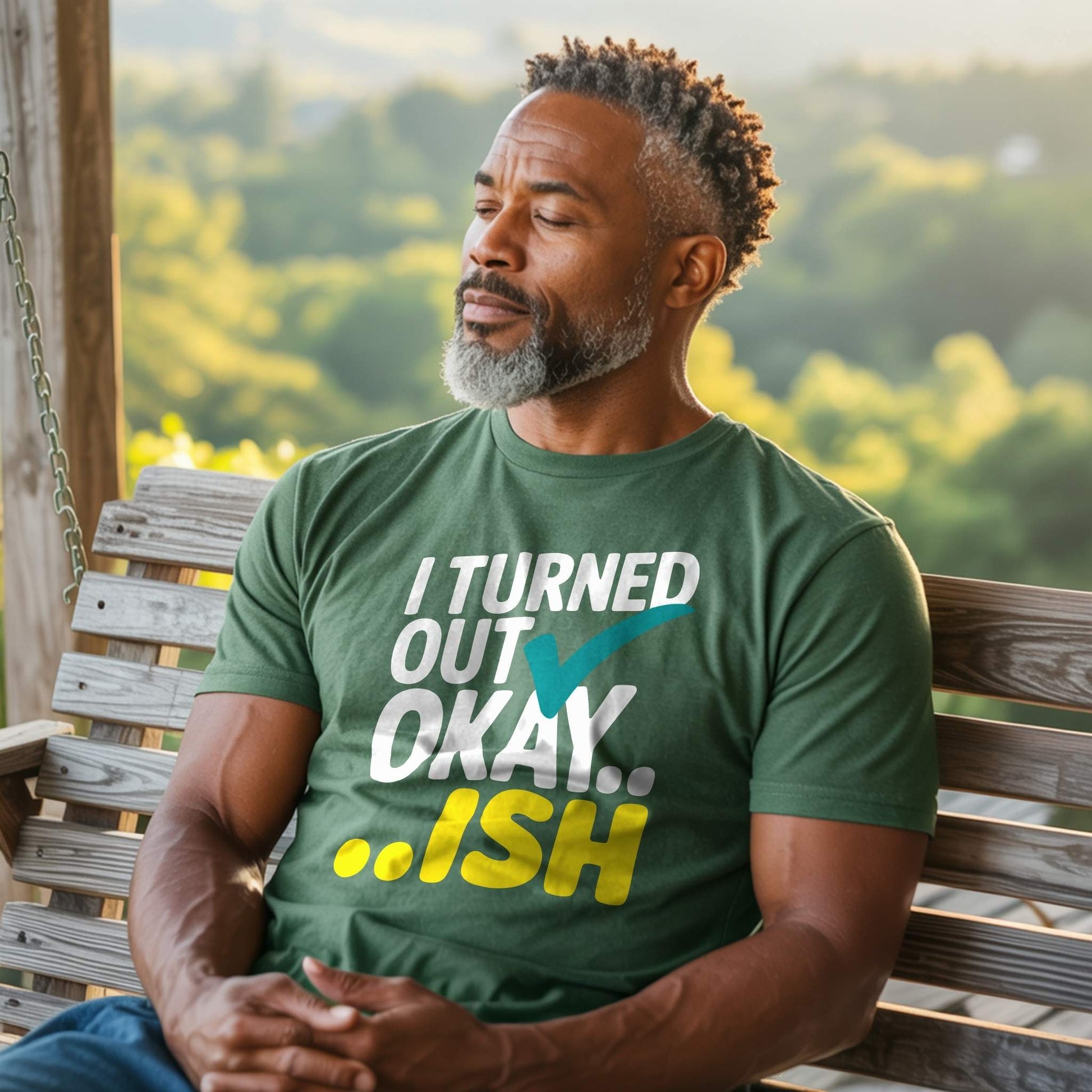 Man in a Forest green "I Turned Out Okay...ish" t-shirt, relaxed on a porch swing, embodying relatable parent mental health.