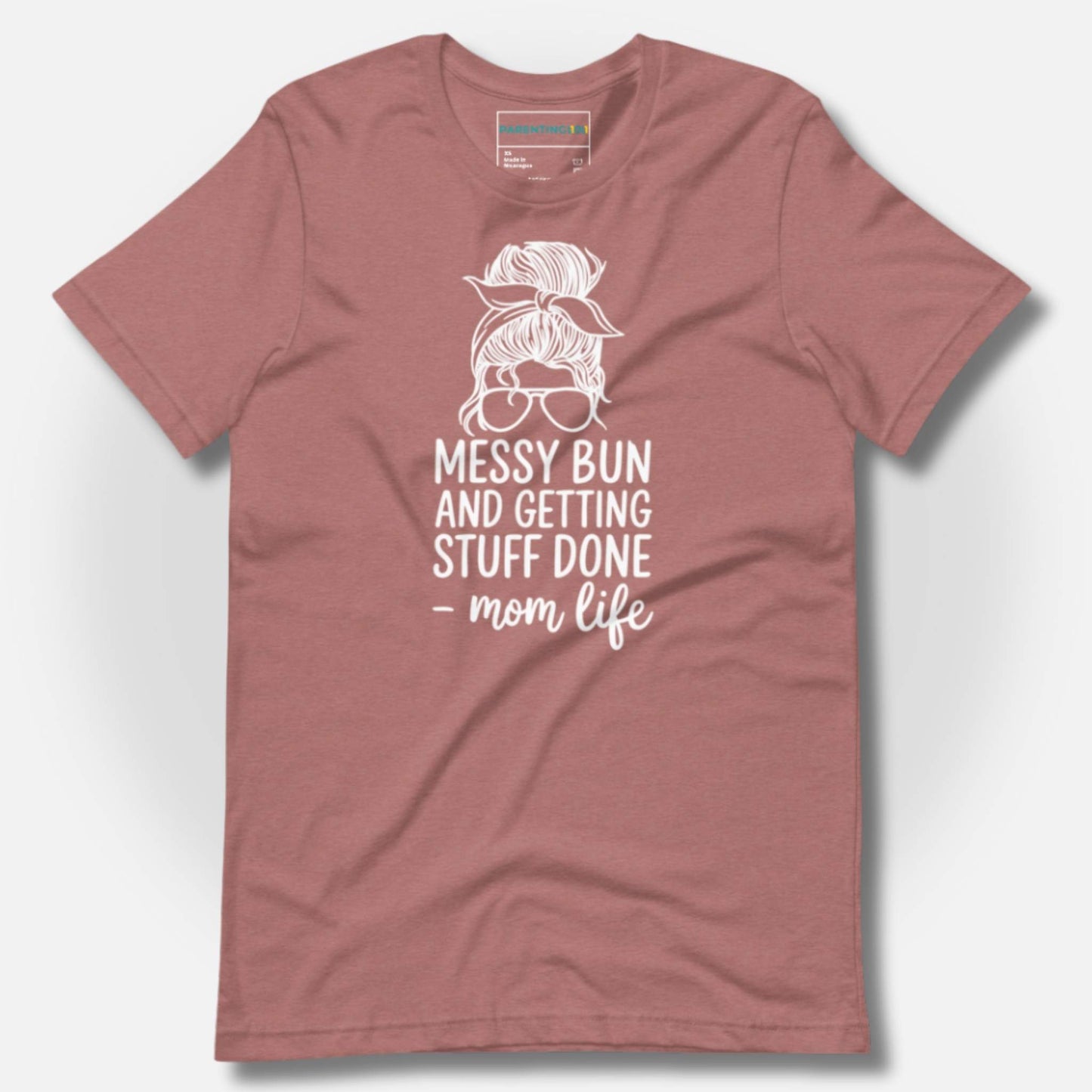 ParentingLOL's soft heather mauve tee with "Messy Bun and Getting Stuff Done - mom life" graphic. A comforting, humorous shirt for moms.