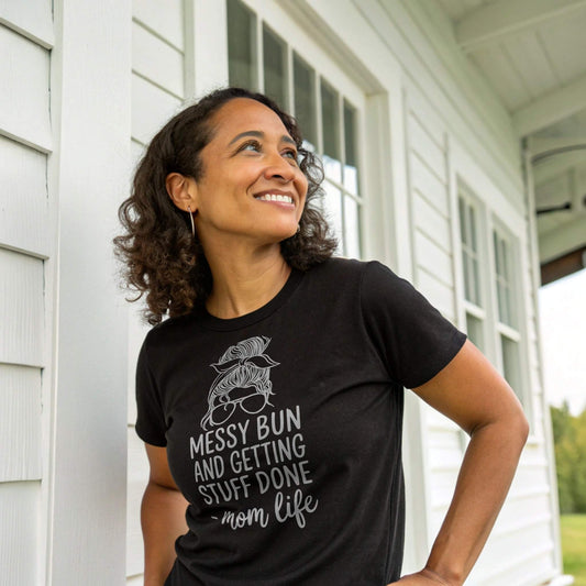 Black t-shirt with "Messy Bun and Getting Stuff Done - mom life" graphic, a stylish funny mom shirt.